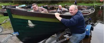  ??  ?? Left: Civil Defence crews load sandbags on to a truck in Kerry. Above: Tim Morey, Evan Morey and John O’Sullivan from Cork remove their boat from Lough Leane in Killarney. Photo: Don MacMonagle