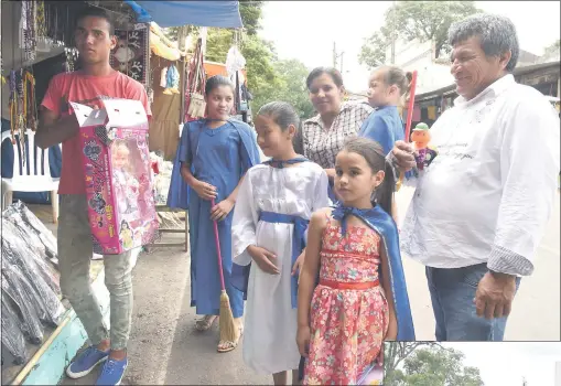  ??  ?? La pequeña Naiana y sus primas y hermanas Gabriela, Montse y Romina, todas con su capa de seda azul, buscan el tradiciona­l “Caacupé poty”, después de haber pagado la promesa a la Virgen de los Milagros.