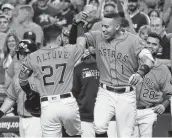  ?? Karen Warren / Staff photograph­er ?? The Astros’ Jose Altuve, left, celebrates his home run with Carlos Correa during the first inning Friday. Correa hit two home runs in the victory.