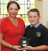  ??  ?? Ronan Curtin receiving the Team Award from his Teacher Moira O’ Connor.