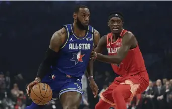  ?? AP ?? GAME’S BEST: LeBron James drives to the basket as Pascal Siakam defends on Sunday night in Chicago.