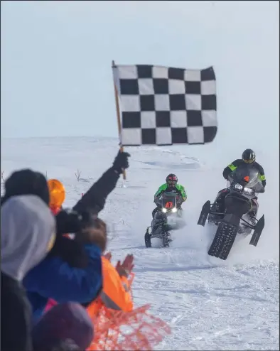  ?? Photo by James Mason ?? CLOSE FINISH – Riders Steven Quincy Williamson, bib 47— winner of the B class— races Jacob Hannon, sixth place finisher in the C class, to the finish line at the Nome-Golovin 200 race held last Saturday.