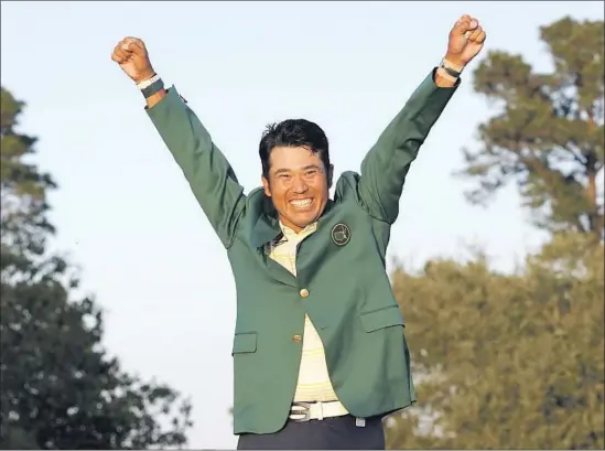  ?? Gregory Bull Associated Press ?? HIDEKI MATSUYAMA, who displays some rare emotion after donning the green jacket, survived a shaky back nine Sunday to capture the Masters championsh­ip.