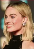  ??  ?? Margot Robbie wearing pink eye makeup on the red carpet at BAFTA earlier this year.