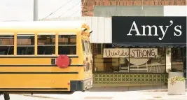  ?? ERIC GAY/AP ?? A school bus passes a “Uvalde Strong” sign placed in the window of a business to honor the victims killed in the recent school shooting at Robb Elementary in Uvalde, Texas, on June 9.