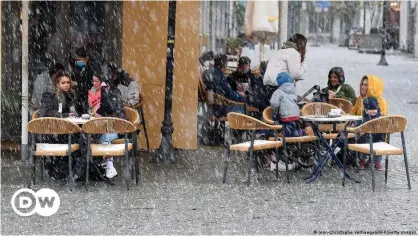  ??  ?? Guests sit outside a cafe in the western German state of Saarland, which partially reopened in early April