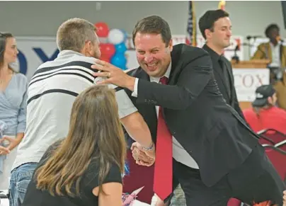  ?? KENNETH K. LAM/BALTIMORE SUN ?? Republican gubernator­ial candidate Dan Cox shakes hands with supporter Joe Skoczelak of Mount Airy at his campaign party Tuesday night at Vigilant Hose Company Event Hall in Emmitsburg.