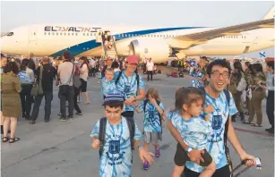  ?? (Menachem Shlomo) ?? THE BLUM FAMILY steps off the chartered Nefesh B’Nefesh flight that arrived in Israel on Wednesday.