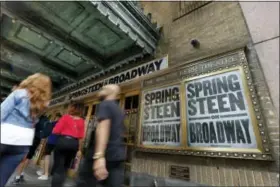  ?? RICHARD DREW — THE ASSOCIATED PRESS ?? People pass the Walter Kerr Theater, home to the Broadway show “Springstee­n on Broadway,” in New York’s Theater District, Friday. The upcoming show will be the one of the latest to offer up tickets for sale using new technology, called Verified Fan, to...