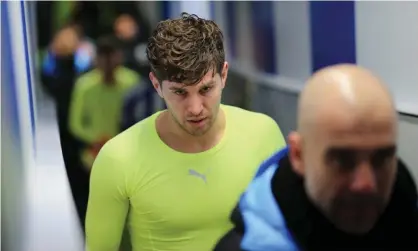  ??  ?? John Stones walks down the tunnel behind Pep Guardiola after Manchester City beat Sheffield Wednesday 1-0 in the FA Cup in March. Photograph: Tom Flathers/Manchester City FC via Getty Images