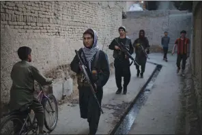  ?? (AP/Felipe Dana) ?? Taliban fighters patrol a neighborho­od in Kabul, Afghanista­n, on Sunday in search of a man accused in a stabbing incident.