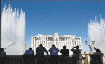  ?? STEVE MARCUS (2020) ?? People photograph the Bellagio Fountains on June 4, 2020. The fountains use recycled water. Despite its reputation for excess, Las Vegas has been factoring climate change into its water plans for years.