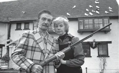  ??  ?? Peter ‘Mr Teasy Weasy' Raymond and his wife Rosalie after Mr Raymond used a .22 rifle to try and scare intruders at their Fifield home in 1980. Ref:132383-9