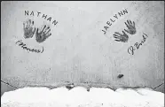  ?? Matthew Jonas / Staff Photograph­er ?? The names and handprints of Mark and Erin Martinez’s son and daughter are seen in the concrete at Two Hunters Park.