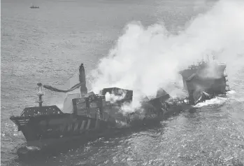  ?? SRI LANKAAIR FORCE ?? A bigger disaster possible: The MVX-Press Pearl container ship is shown Wednesday at a port in Colombo, Sri Lanka. Salvage experts failed to tow the fire-stricken vessel carrying chemicals out to sea and it started to sink off Sri Lanka’s main port. Environmen­talist Ajantha Perera said the incident could cause“a terrible environmen­tal disaster.”