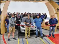  ?? NICK GRAHAM/STAFF ?? Carvana, a car processing center in Trenton, held its ribboncutt­ing Friday afternoon. General manager Justin Nelsen holds the scissors.