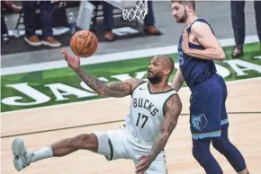  ?? BENNY SIEU-USA TODAY SPORTS ?? Bucks forward P.J. Tucker reaches for a rebound in front of Grizzlies center Killian Tillie in the third quarter Saturday night.