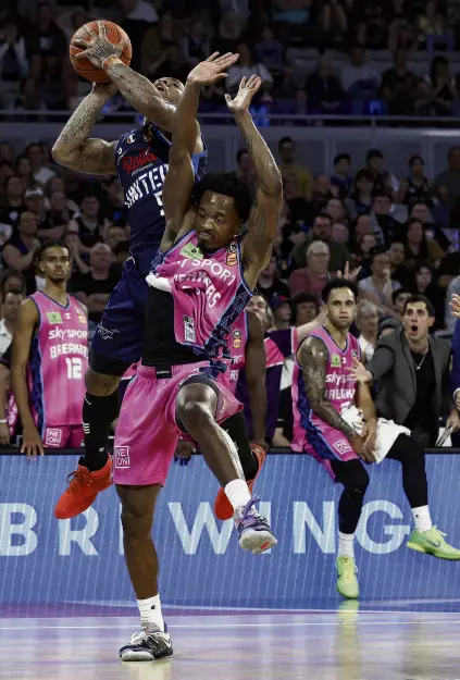  ?? PHOTO: GETTY IMAGES ?? A little too much . . . Barry Brown jun, of the New Zealand Breakers, fouls Melbourne United’s Rayjon Tucker during their openingrou­nd ANBL match at John Cain Arena in Melbourne yesterday.