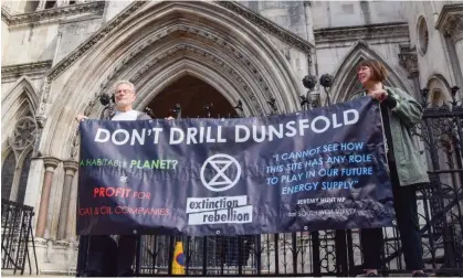  ?? Vuk Valcic/ZUMA Press Wire/Shuttersto­ck ?? Climate protesters outside the Royal Courts of Justice during the judicial review of planning permission for the Dunsfold site. Photograph: