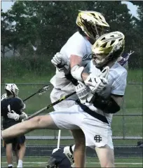  ?? MATTHEW B. MOWERY — MEDIANEWS GROUP ?? Detroit Country Day’s Luke Grove (33) and Oliver Aaron (10) celebrate the Yellowjack­ets’ 12-10win over East Grand Rapids in the Division 2boys lacrosse semifinals at Howell’s Parker Middle School on Wednesday.