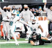  ?? DAVID SANTIAGO dsantiago@miamiheral­d.com ?? Pro Football Focus finds that the play of safety Jevon Holland — returning an intercepti­on 99 yards for a TD against the Jets, above — is unsurpasse­d this season.