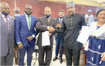  ??  ?? MD/CEO of Kano Electricit­y Distributi­on Company (KEDCO), Dr Jamil Isyaku Gwamna (2nd right) shake hands with the Vice Chancellor, Skyline University Nigeria, Dr. Sudhakar Kota, after signing MoU to enhance training and education between both parties in Kano recently.