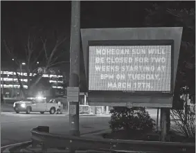  ?? SEAN D. ELLIOT/THE DAY ?? Crews erect barricades at entrances to the Mohegan Sun on Tuesday as the casino closed for a two-week coronaviru­s shutdown.