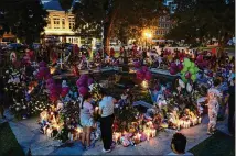  ?? JAE C. HONG/ASSOCIATED PRESS ?? On Saturday, people visit the memorial set up in the Uvalde, Texas, town square to honor the victims killed last week at Robb Elementary School.