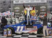 ?? WADE PAYNE — THE ASSOCIATED PRESS ?? Denny Hamlin, center, celebrates after winning a NASCAR Cup Series race on Sunday in Bristol, Tenn.