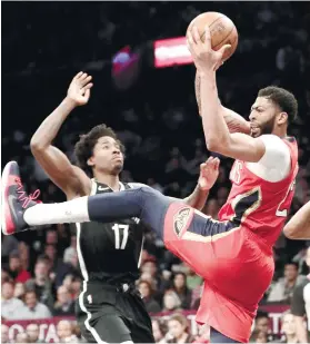  ?? AP FOTO ?? MY BALL. New Orleans’ Anthony Davis grabs the rebound over Brooklyn Nets’ Ed Davis (17) .