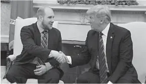  ??  ?? U.S. President Donald Trump shake hands with Joshua Holt. (Photo: Getty Images)
