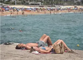  ?? EMILIO MORENATTI/AP FILE ?? A beach in Barcelona, Spain, is crowded on June 19. Like much of the rest of the Northern Hemisphere, Europe is coping with a heat wave.