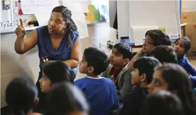  ?? RICHARD LAUTENS/TORONTO STAR ?? Teacher Carlene Powell instructs a Grade 3 class on the finer points of numeracy at the Eldorado public school in Brampton.