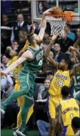  ?? WINSLOW TOWNSON — THE ASSOCIATED PRESS ?? Boston’s Aron Baynes dunks over the Lakers’ Brandon Ingram (14) during the third quarter of Boston’s 107-96 win in Boston on Wednesday.