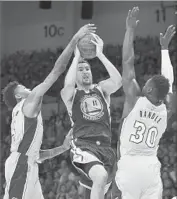  ?? Denis Poroy Associated Press By Tania Ganguli ?? BRANDON INGRAM of Lakers, left, harasses Golden State’s Klay Thompson as he tries to shoot.