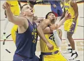  ?? Robert Gauthier Los Angeles Times ?? THE LAKERS had some success in slowing down Nikola Jokic, left, when Rui Hachimura guarded him.