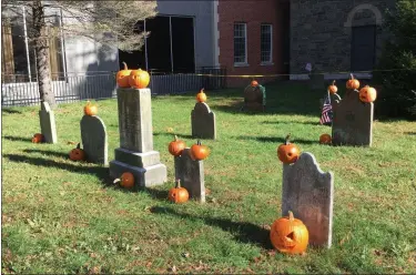  ?? BRIAN HUBERT — DAILY FREEMAN ?? Pumpkins that were carved during an event on Saturday at the Old Dutch Church in Kingston, N.Y., stand atop and alongside gravestone­s in the church’s historic cemetery on Monday.