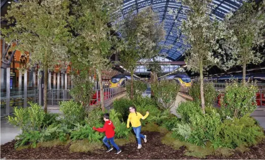  ??  ?? Take a bough: Children play yesterday among trees planted at St Pancras station in London to mark 25 years of Eurostar