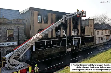  ?? Jonathan Myers ?? Firefighte­rs were still working at the site of the blaze at the former Tylorstown Working Men’s Club & Institute yesterday