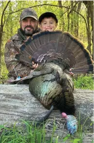  ?? (Special to The Commercial/Brad Young) ?? Although he spends most of his spring mornings before turkey season in the woods looking for poachers, Col. Brad Young, Arkansas Game and Fish Commission chief of enforcemen­t, was able to introduce his son, Hudgin, to turkey hunting.