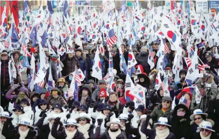  ?? — Reuters ?? Members of a South Korean conservati­ve civic group take part in an anti-north Korea protest in Seoul on December 8.