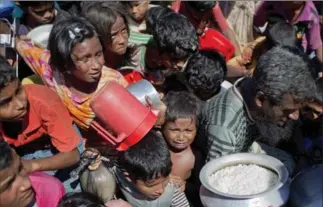  ?? A.M. AHAD, THE ASSOCIATED PRESS ?? Rohingya Muslims, who fled Myanmar to Bangladesh, crowd each other while waiting to receive food distribute­d by a Turkish aid agency at the Thaingkhal­i refugee camp in Ukhiya, Bangladesh, Tuesday.