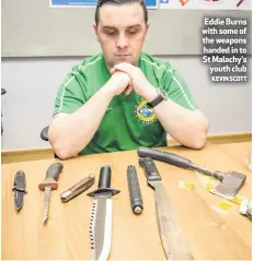  ?? KEVIN SCOTT ?? Eddie Burns with some of the weapons handed in to St Malachy’s
youth club