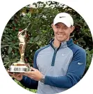  ??  ?? Rory McIlroy with the winner’s trophy.