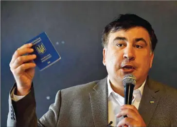  ?? JANEK SKARZYNSKI/AFP ?? Former Georgian President Mikheil Saakashvil­i meets with Ukrainian citizens in Warsaw, Poland, on August 6.