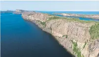  ??  ?? Shonto Catholique, left, is a member of the Ni Hat’ni Dene Rangers, who will staff and maintain the protected area, which includes the cliffs of the Pethei Peninsula overlookin­g Great Slave Lake.