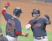  ?? KEVIN M. COX — THE ASSOCIATED PRESS ?? Red Sox designated hitter J.D. Martinez celebrates with Rafael Devers after hitting a grand slam in the first inning of Game 2 of the ALCS on Saturday against the Astros.