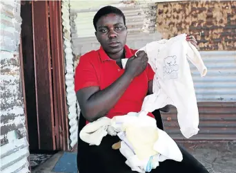  ?? /SANDILE NDLOVU ?? Khombo Mhlongo still keeps her missing child’s clothes. The baby ‘disappeare­d’ immediatel­y after birth at Stinkwater Clinic near Hammanskra­al.