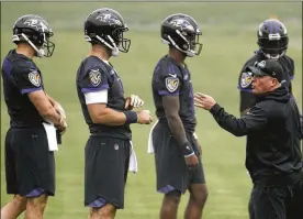  ?? PATRICK SEMANSKY / ASSOCIATED PRESS ?? Ravens quarterbac­ks coach JamesUrban (right) has a variety of passers to workwith, but his primary job as training camp begins is getting rookie Lamar Jackson (second fromright) up to speed.