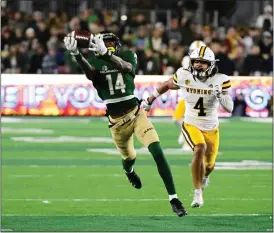  ?? ANDY CROSS — THE DENVER POST ?? Colorado State Rams wide receiver Tory Horton (14) hauls in a long pass against Wyoming Cowboys cornerback Cameron Stone (4) in the second quarter at Canvas Stadium November 12, 2022.